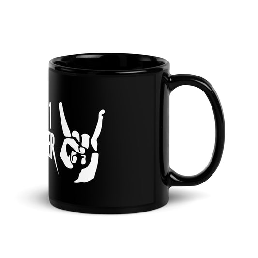 Right-handed angled view of the black It's 1 Louder ceramic mug showing the glossy handle, finish, and partial rock-horns logo with lightning bolts, statement coffee cup for rock fans.