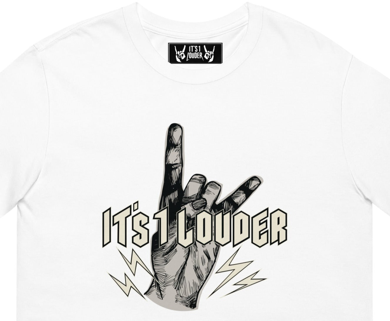 White short sleeve shirt with a graphic of a hand doing the devil horns symbol for rock and roll. The words IT'S 1 LOUDER is written across the hand in a beige colour. The hand is of light grey colour. 4 small bolts of lightning are at the bottom of the palm and below the words "It's 1 Louder". Also shown, is the inside label of the T-shirt that shows two hands doing the rock symbol. In between the 2 hands is written the words: It's 1 Louder.