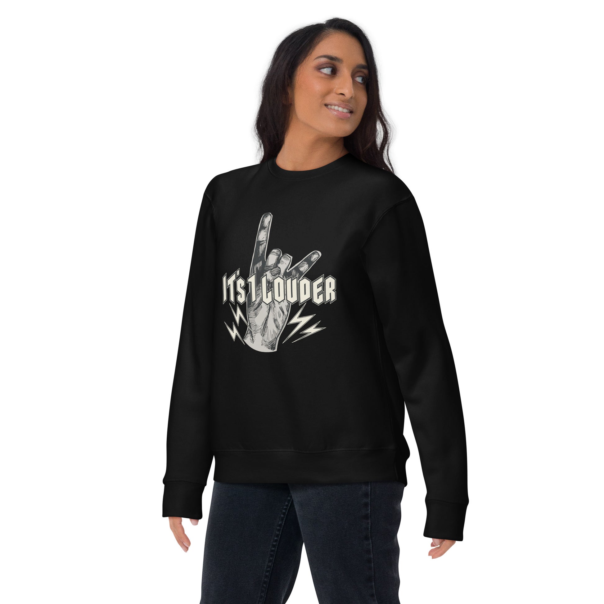 Off centered front view of a brown skinned woman looking off to her left. She's wearing a black sweater with the It's 1 Louder logo in big in the chest area. It's a rock and roll apparel suited for a rock concert attire showing almost a punk rock style.