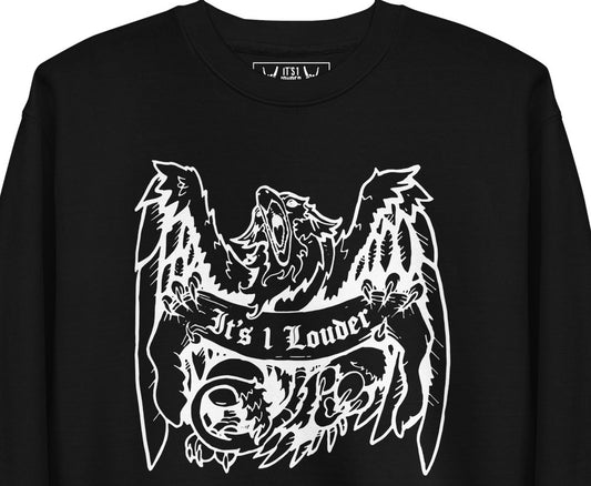 Black sweater with an image of a griffin which is a half-eagle half lion beast. The griffin is holding a banner. The words "It's 1 Louder" is written on the banner. The griffin has its wings spread wide and beak fully open. The entire graphic is in white. This sweater definitely gives off a punk rock style or rock style look. Image is a close up of the front of the tee where you see the griffin design and part of the inside label.