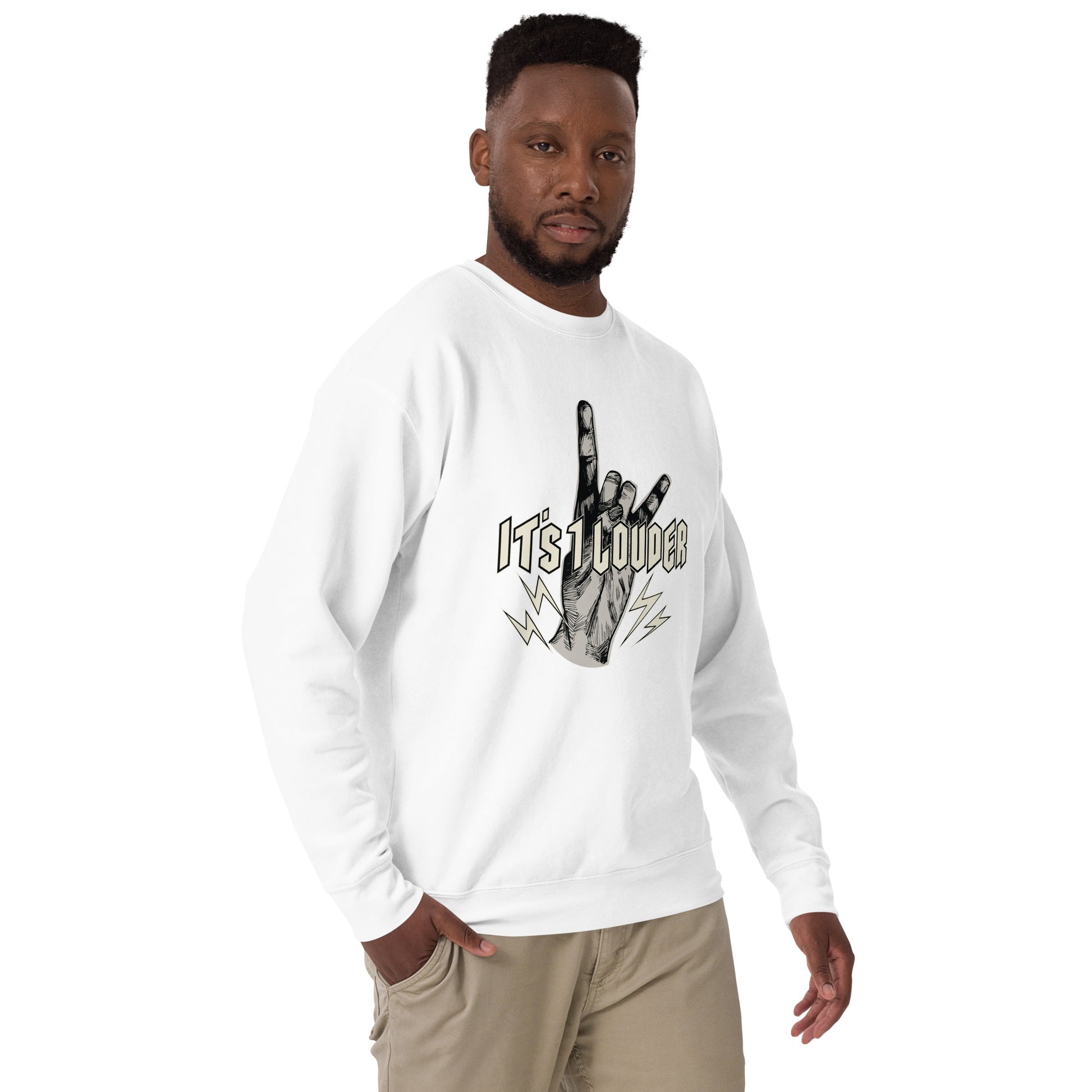 Front view of a black man looking straight ahead wearing a white rock style sweater with a big design across the chest. There's a hand doing the finger devil horns, the universal symbol for rock and roll, and the words It's 1 Louder written in front of hand. It's a rock and roll attire suited for rockstars, rock fans and rock outfits.